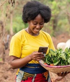female african farmer making use of her phone